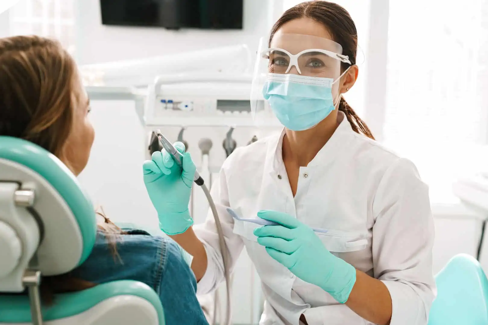 A patient receiving a gentle dental cleaning at Mantena Dental